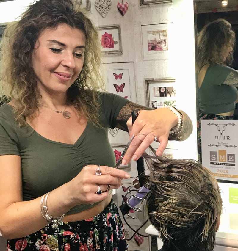 Carla cutting a client's hair